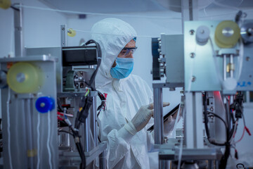 Technician worker wearing protective suite , glove are inspect ion with check  face mask...