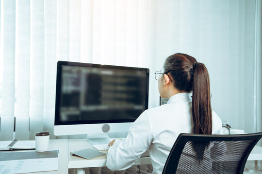 Software developers are analyzing about the code written into the program on the computer in office room.