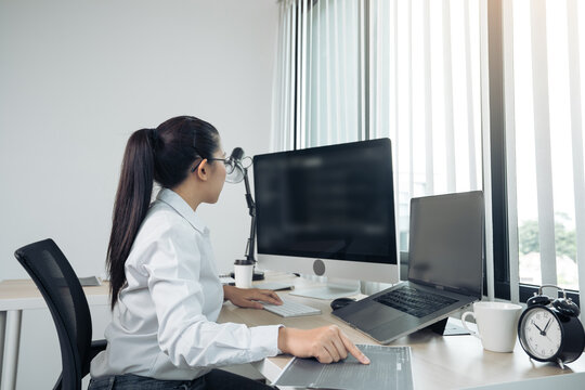 Software developers are analyzing about the code written into the program on the computer in office room.