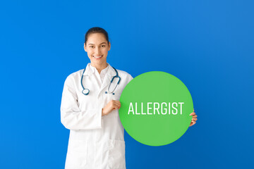 Portrait of female doctor holding poster with text ALLERGIST on color background