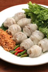 Thai Traditional Dessert, Tapioca balls with pork filling serve with vegetable, Steamed Rice Skin Dumplings Made From Glutinous Rice Filled with Minced Pork and Sweet Pickled Daikon Radish.