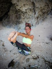 Outdoor yoga practice. Attractive woman practicing Ubhaya Padangusthasana, Wide-Angle Seated Forward Bend. Strengthen legs and core. Self care concept. Yoga retreat. Bali, Indonesia