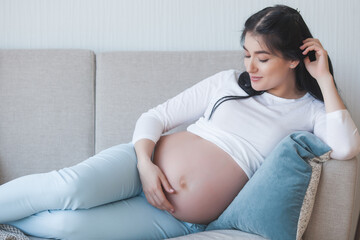Young pregnant woman indoors. Expecting female