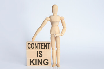 Wooden man shows with a hand text CONTACT IS KING concept on the wooden block