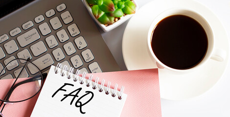 Office supplies, devices, coffee and glasses on white table with text FAQ