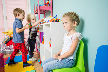 Kindergarten newcomer is distrustfully studying new surrounding