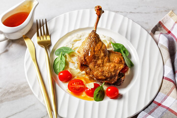 Roasted duck leg with puree and orange sauce