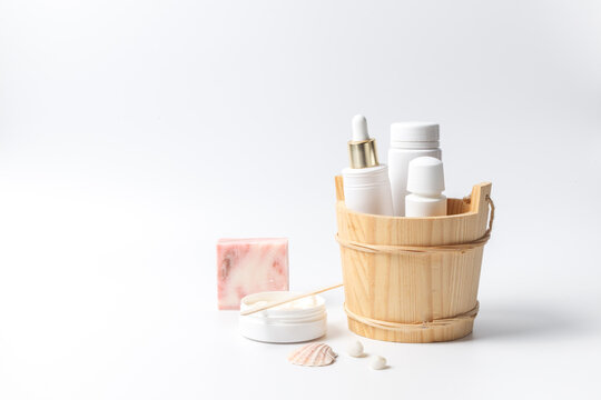 Cosmetics for spa care without labels in a wooden stand. On a white background, with space