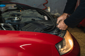 Mechanic's hands repairing car headlight. Concept of automobile mechanics