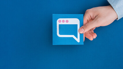 Male hand holding Speech balloon shape card.