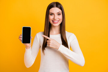 Naklejka premium Portrait of adorable person toothy smile indicate finger empty space display isolated on yellow color background