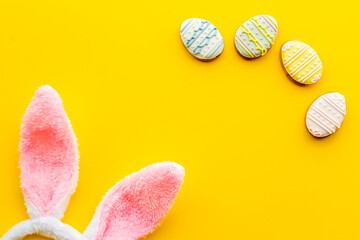 Happy Easter. Bunny ears with colorful eggs cookie, top view