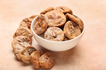 Bowl with tasty dried figs on table