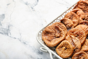Tray with tasty dried figs on table