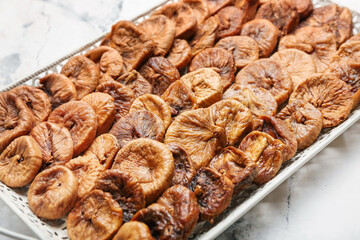 Tray with tasty dried figs on table