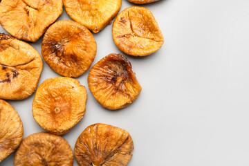 Tasty dried figs on light background
