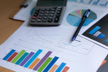 business chart with pen and calculator