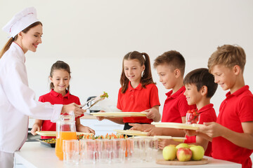 Pupils receiving lunch in school canteen