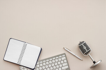 Microphone with keyboard on blogger table, flat lay