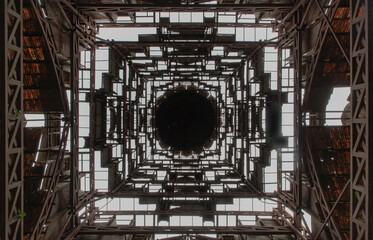 Looking up into dome ceilings there are vents and receiving light inside the architecture of an...