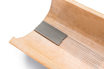 Bamboo tray with acupuncture needles on white background