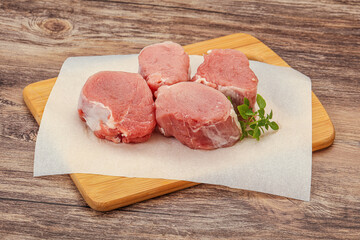 Raw pork medallion served rosemary