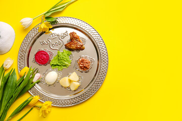 Passover Seder plate with traditional food on color background