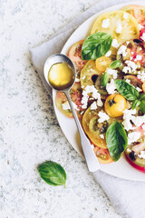 Tomato salad with basil, feta cheese and olive oil