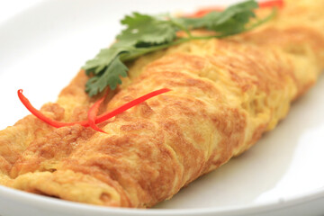 closeup of a plate with a typical tortilla de patatas, spanish omelet, on a set table