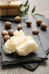 Fototapeta na wymiar Shea butter with nuts on table, closeup
