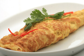 closeup of a plate with a typical tortilla de patatas, spanish omelet, on a set table
