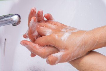 Fototapeta premium Someone washing their hands with soap.