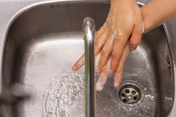 Someone washing their hands with soap.