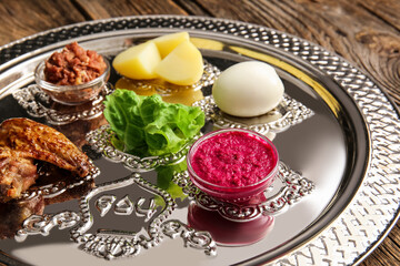 Passover Seder plate with traditional food on table, closeup