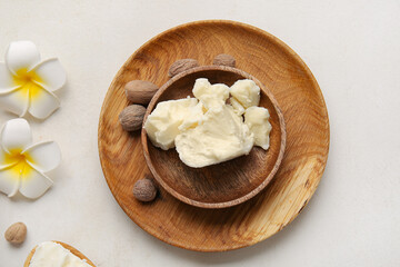 Plate with shea butter on light background
