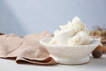 Plate with shea butter on table