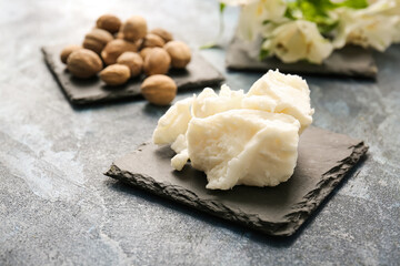 Shea butter and nuts on color background