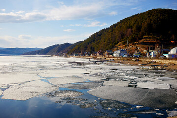 Lake Baikal in the spring. The Village Of Listvyanka. Ice floes and open water.