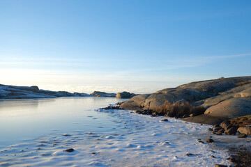 Ice and snow on a frozen lake between scaurs