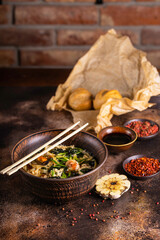 Asian style soup with udon noodles and seafood. Delicious scene.
