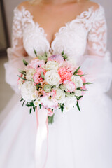 bride holding a bouquet of flowers in a rustic style, wedding bouquet. Soft focus