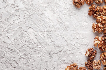 Peeled walnut halves in a pile, isolated on a light gray background, copy the space. Food menu