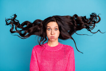 Portrait of positive person hold breath cheeks have good mood hair flying isolated on blue color...
