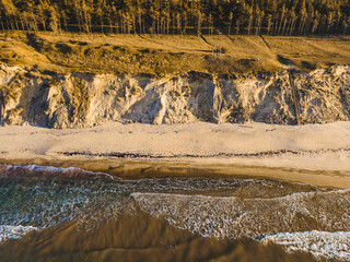 Jurkalne steep shore at autumn sunset with small waves in the sea, Latvia, Jurkalne. 2020 autumn