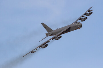 B52 Bomber turns towards the camera against a blue sky