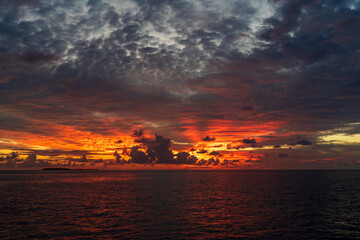 Naklejka na ściany i meble Dramatic sky, colors of sunset in Maldives.