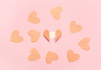 Origami hearts on color background