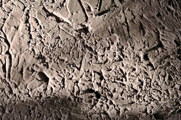 abstract textured plaster putty brush strokes with light and shadow on wall background