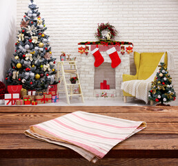 Red napkin on wooden table and Christmas background.
