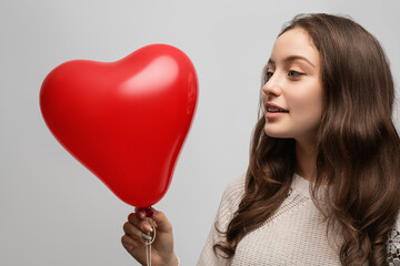 Girl with red balloon heart
